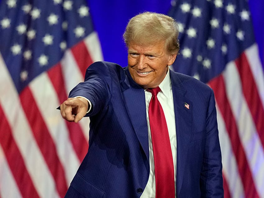 Republican presidential nominee former President Donald Trump points to a person in the cr