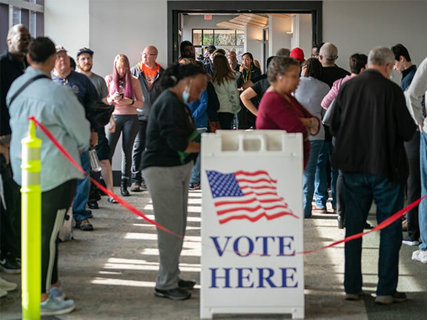 MARIETTA, GA - NOVEMBER 26- People are seen in line to vote on the first day of early voting in Cobb County on Saturday, November 26, 2022 in Marietta, GA. (Photo by Elijah Nouvelage for The Washington Post via Getty Images)