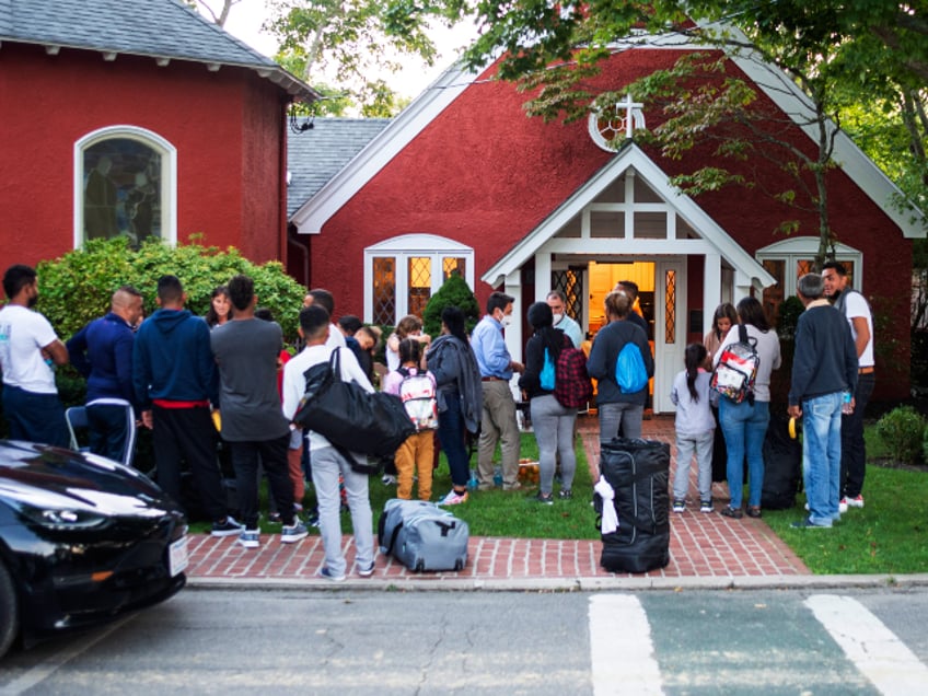 Immigrants gather with their belongings outside St. Andrews Episcopal Church, Wednesday Sept. 14, 2022, in Edgartown, Mass., on Martha's Vineyard. Florida Gov. Ron DeSantis on Wednesday flew two planes of immigrants to Martha's Vineyard, escalating a tactic by Republican governors to draw attention to what they consider to be the Biden administration's failed border policies. (Ray Ewing/Vineyard Gazette via AP)