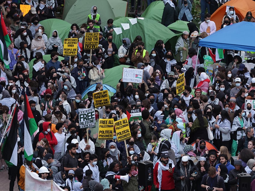 WASHINGTON, DC - APRIL 25: Activists and students participate in an encampment protest at the University Yard at George Washington University on April 25, 2024 in Washington, DC. Student Activists at George Washington University have joined a range of campuses across the United States who have started encampments to call on their universities to divest financial ties from Israel. (Photo by Alex Wong/Getty Images)