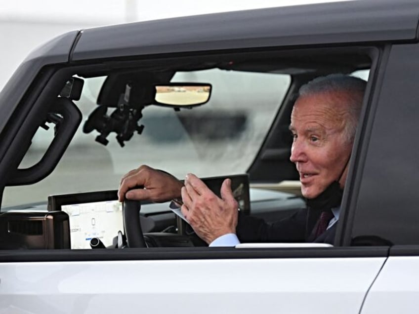 US President Joe Biden test drives an electric hummer as he tours the General Motors Facto