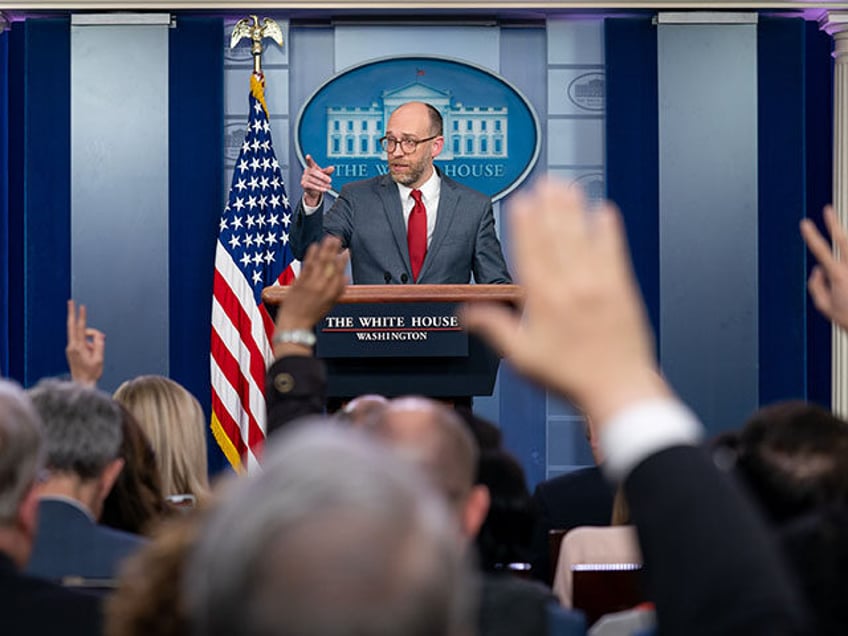 Reporters raise their hands to ask a question of Acting Director of the Office of Manageme