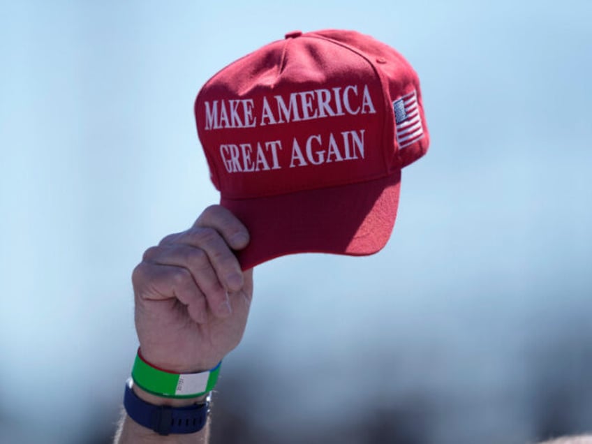 An attendee waves a hat ahead of a campaign rally for Republican presidential candidate fo