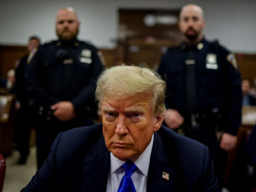 Former U.S. President Donald Trump sits at the defendant's table inside the courthous