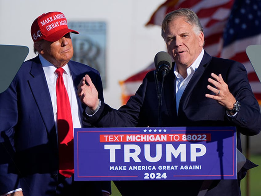 Republican presidential candidate former President Donald Trump listens as Michigan Senate