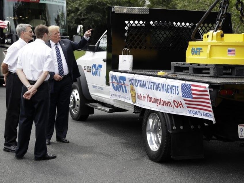 President Donald Trump talks with City Machine Technologies president and general manager Michael Kovach, left, and his son, vice president of engineering Chip Kovach, as they look at an industrial magnet as he participates in a "Made in America Product Showcase" at the White House, Monday, July 23, 2018, in …