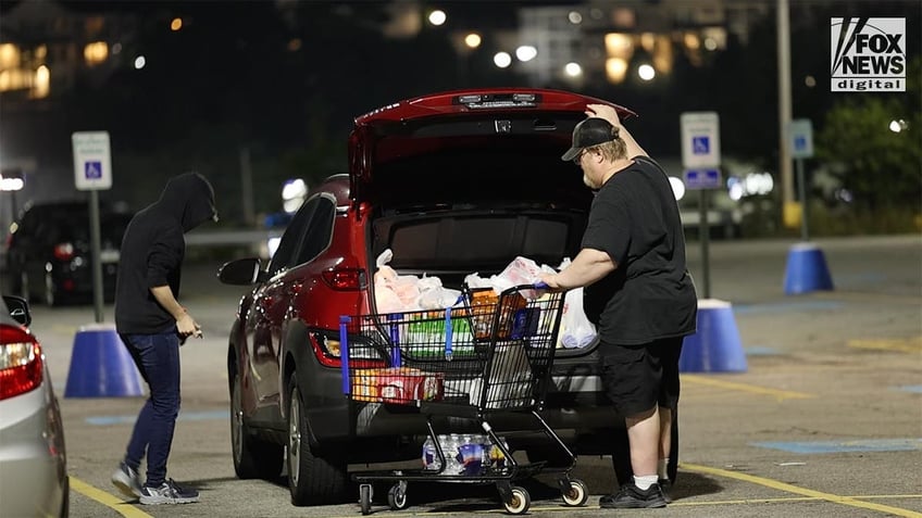 Trump assassin's father Thomas Crooks with a full shopping cart in the carpark of a supermarket.