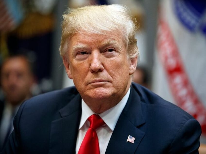 President Donald Trump listens during a meeting of the President's National Council o