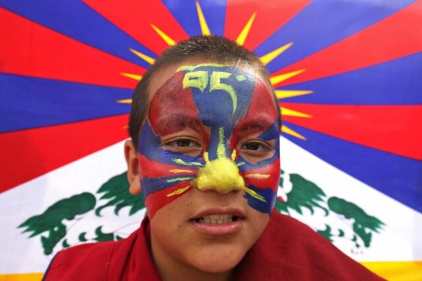 A Tibetan boy in India's hill town of Dharamsala attends a rally marking 65 years since th