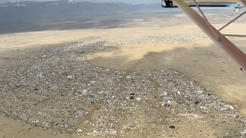 exodus begins thousands attempt to flee burning man