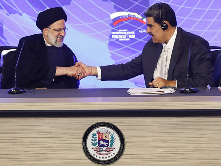 Venezuelan President Nicolas Maduro (R) and Iranian President Ebrahim Raisi (L) attend Ven