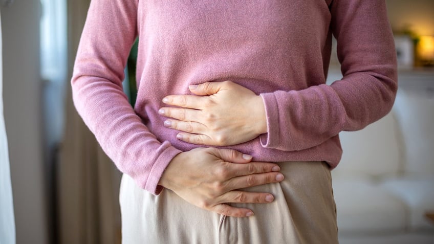 Woman holding gut