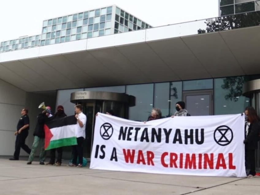 extinction rebellion climate activists occupy international criminal court to protest israel