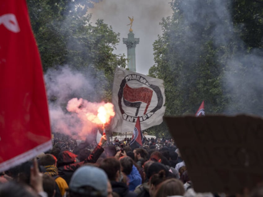 Protesters hold banners during a demonstration against the far-right and racism in central