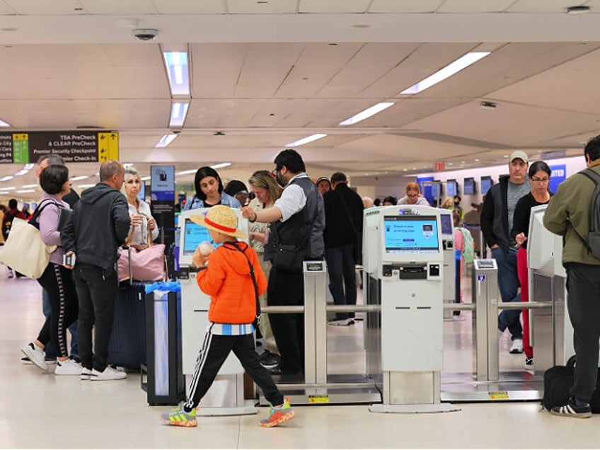 NEWARK, NEW JERSEY - MAY 14: People check in for their flights in Terminal C at Newark Lib