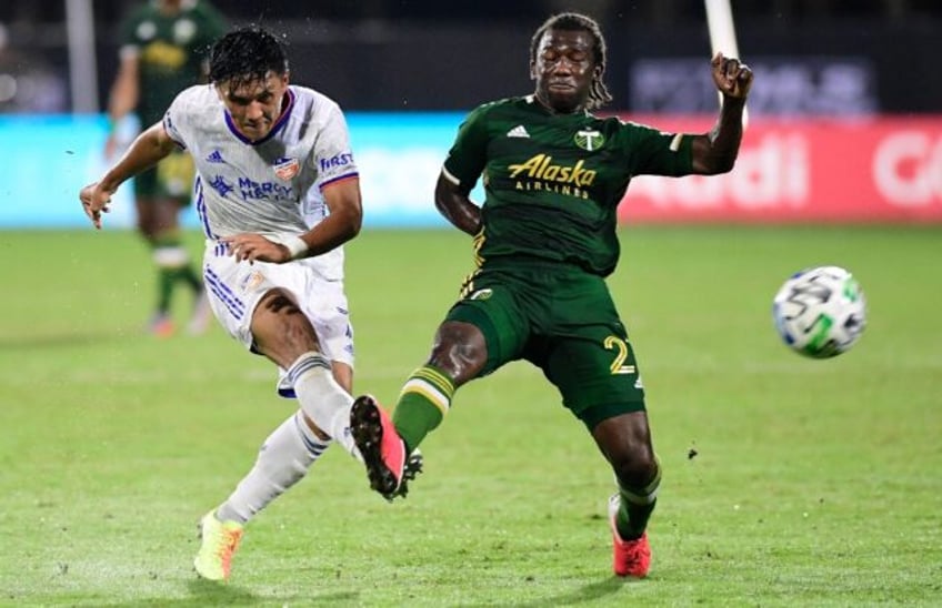 Japanese striker Yuya Kubo, left, of FC Cincinnati -- shown shooting past Portland's Diego