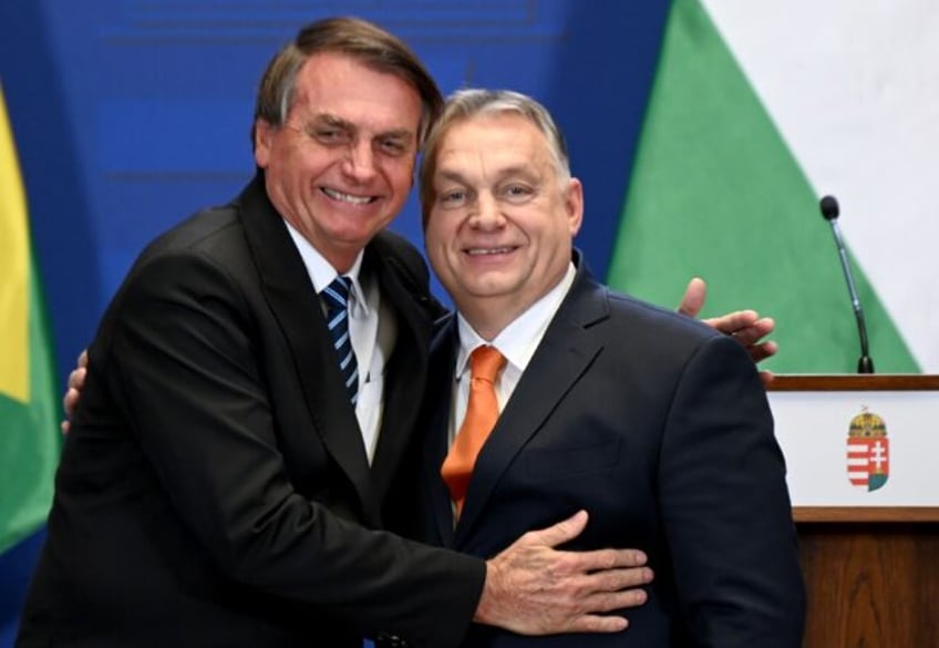 Hungary's Prime Minister Viktor Orban (R) and Brazil's President Jair Bolsonaro hug after