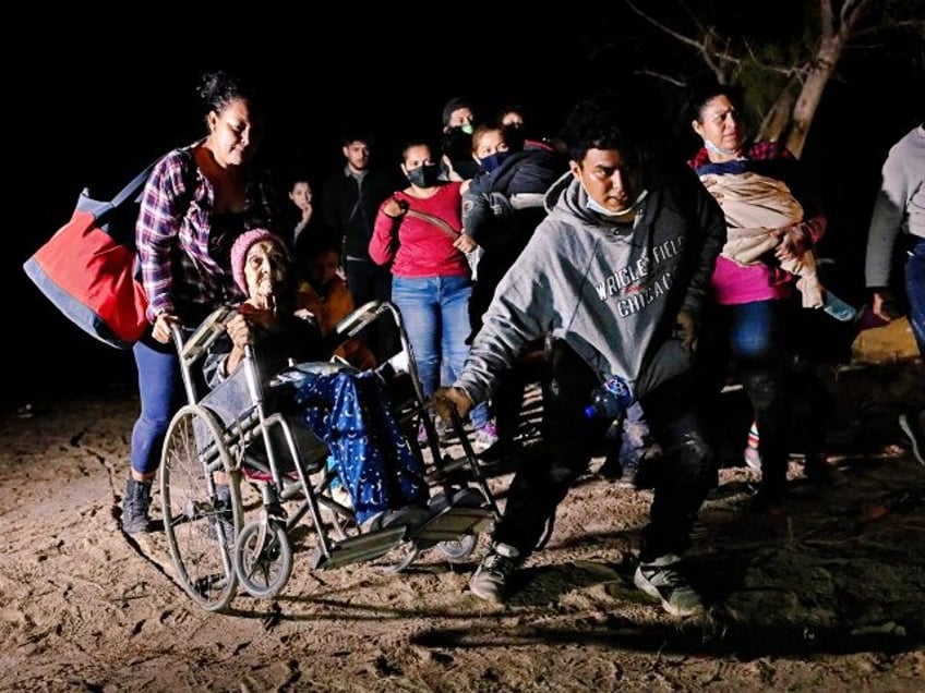 ROMA, TEXAS - APRIL 29: Honduran immigrant Trinidad Tabora, 93, is wheeled from the bank o