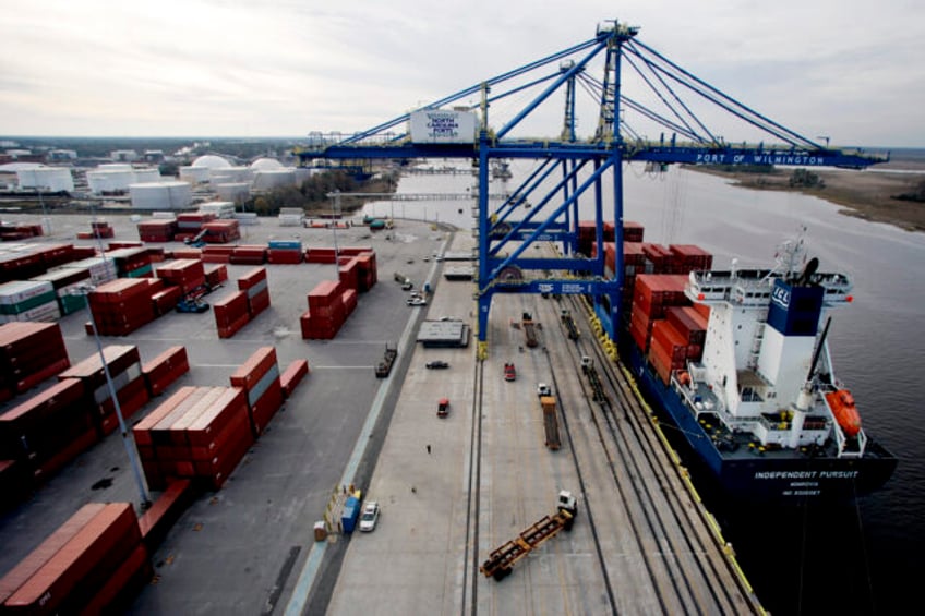 A gantry crane unloads shipping containers from the cargo ship Independent Pursuit at the