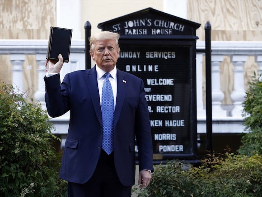 President Donald Trump holds a Bible as he visits outside St. John's Church across Lafayet