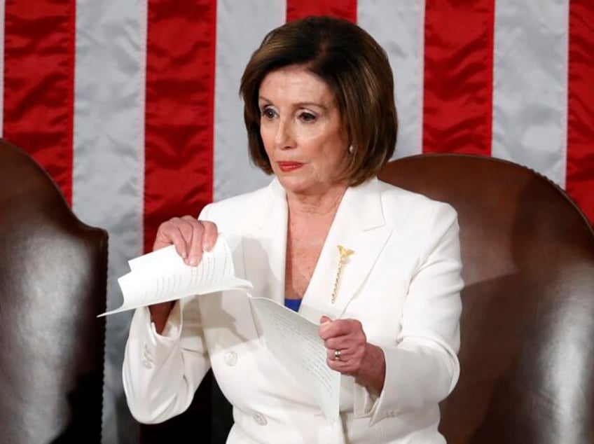 FILE - House Speaker Nancy Pelosi of Calif., tears her copy of President Donald Trump&#039