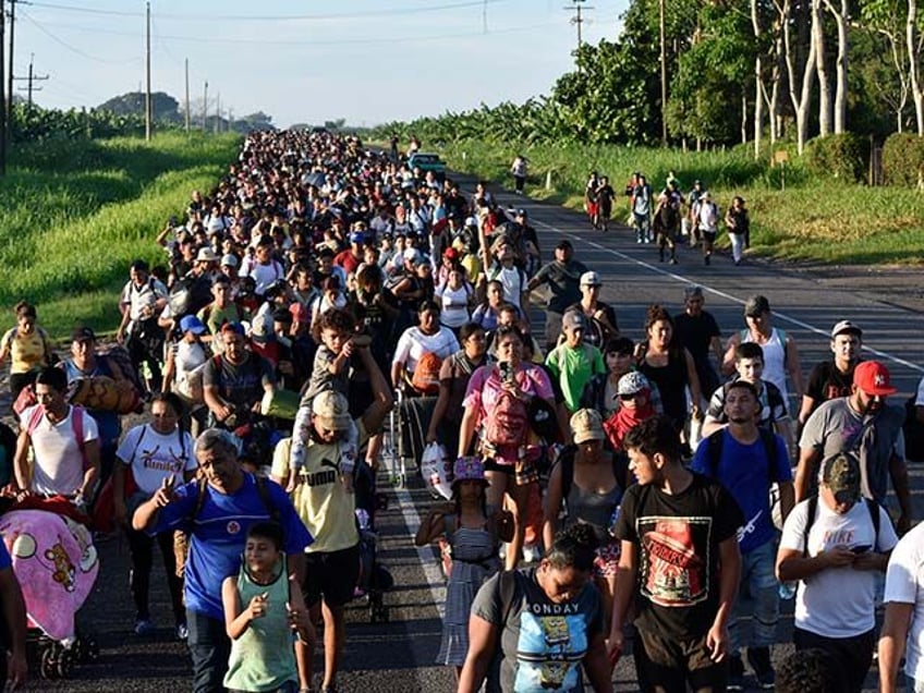 Migrants walk along the highway through Suchiate, Chiapas state in southern Mexico, July 2