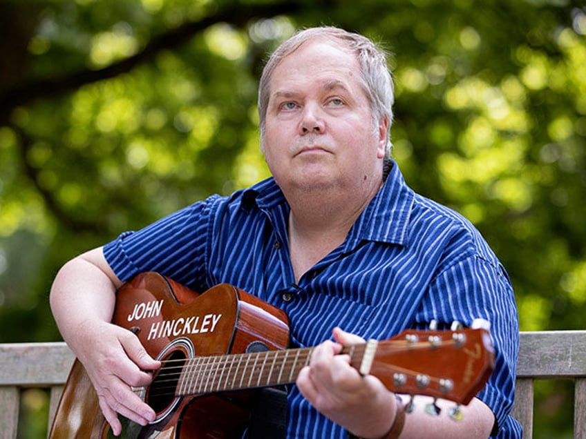 John Hinckley Jr. plays his guitar in Williamsburg, Virginia, on September 14, 2022. - Mor