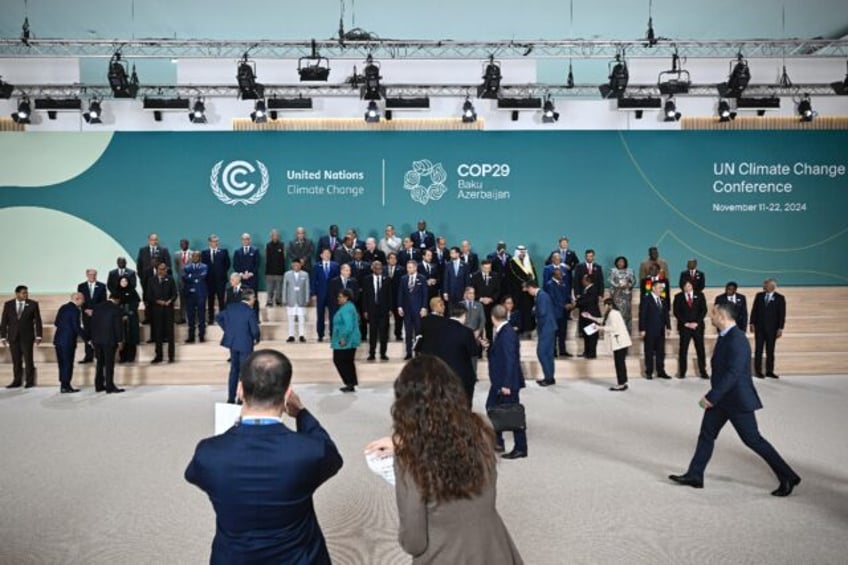 Leaders and delegates arrive for a family photo during the United Nations Climate Change C