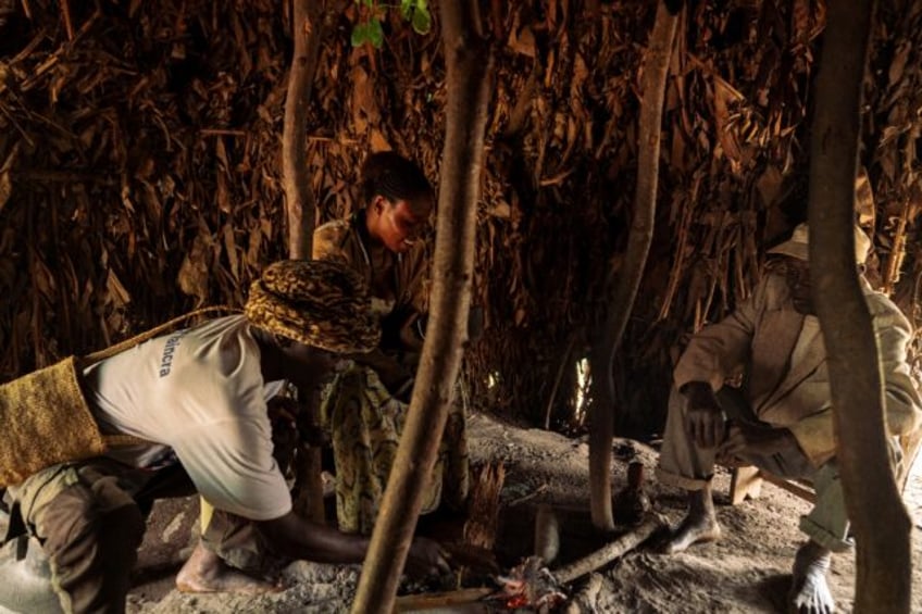 Congolese healer Julie Kaviavu (C) preparing a ritual to commune with the dead