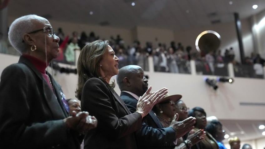 Church elder Joy Hollingshed, left, and Democratic presidential nominee Vice President Kamala Harris attend a service at the Church of Christian Compassion on Sunday, Oct. 27, 2024 in Philadelphia.