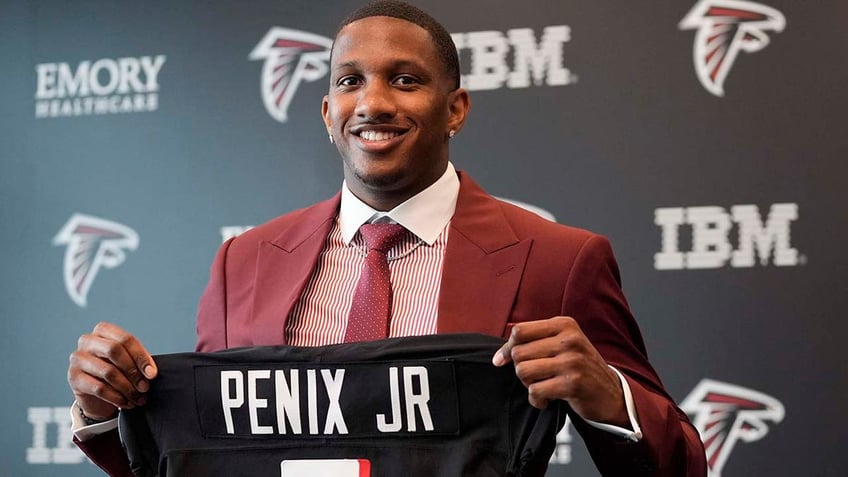 Michael Penix Jr shows his jersey