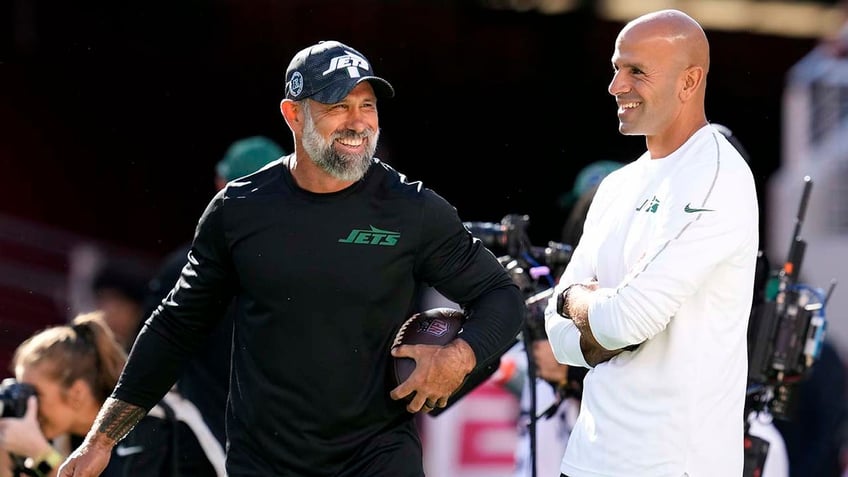 Jeff Ulbrich and Robert Saleh laugh