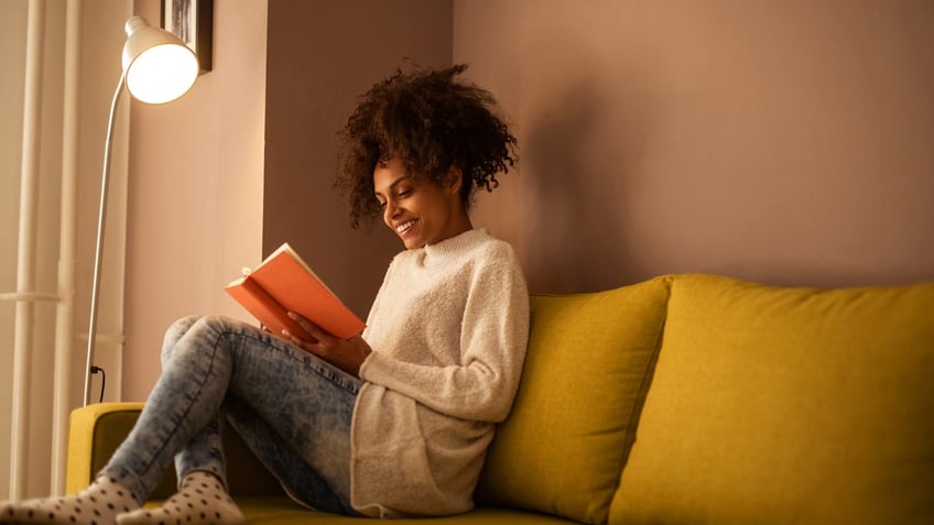 Woman reading a book at home