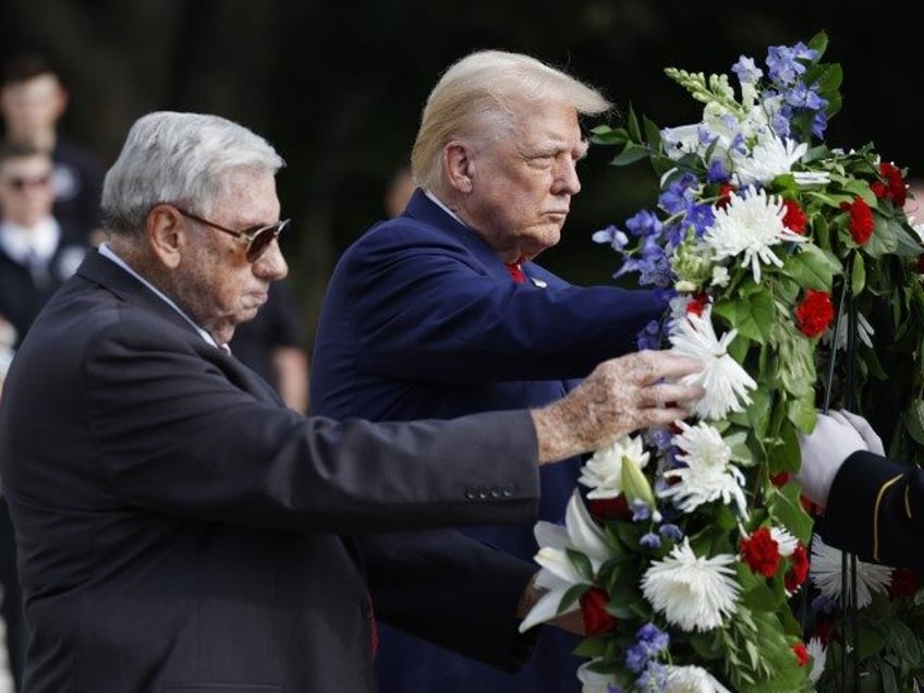 Republican presidential nominee, former U.S. President Donald Trump stands alongside Bill