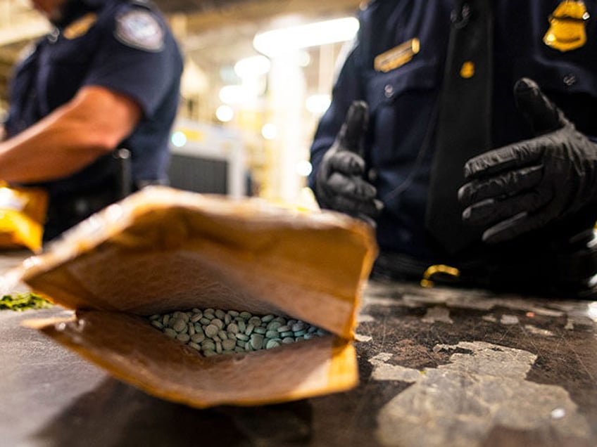 An officer from the US Customs and Border Protection, Trade and Cargo Division finds Oxyco