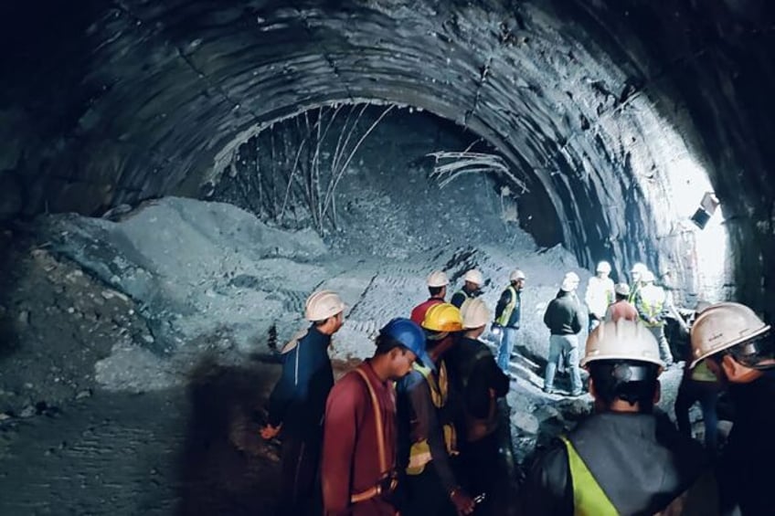 families of indian workers trapped in tunnel pray for rescue