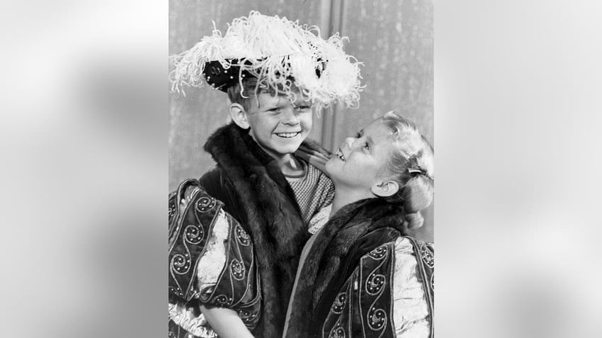 Johnny Whitaker and Anissa Jones in costume smiling