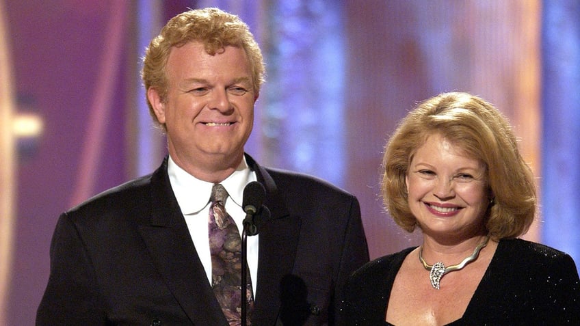 Johnny Whitaker and Kathy Garver standing on stage and smiling