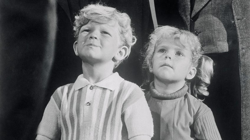 Johnny Whitaker and Anissa Jones looking up during a scene of Family Affair