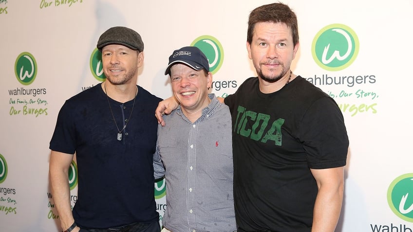 Donnie Wahlberg, Paul Wahlberg and Mark Wahlberg (left to right) attend the Wahlburgers Coney Island VIP Preview Party at Wahlburgers Coney Island on June 23, 2015, in New York City.