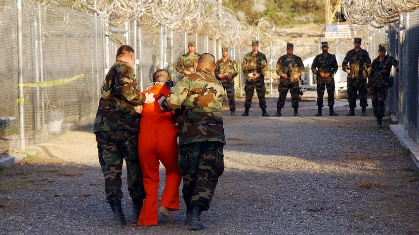 Prisoner escorted in Gitmo