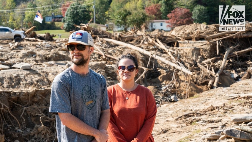 Jesse and Mekenzie Craig stand before piles of debris in "Craigtown"