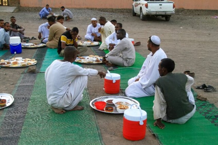 Muslims wait to break their daytime fast in the army-controlled Sudanese city of Gedaref