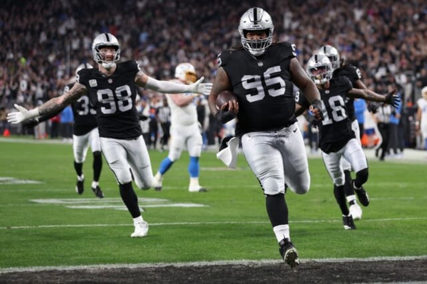 Las Vegas Raiders defensive tackle John Jenkins rumbles over for a touchdown in a 63-21 thrashing of the Los Angeles Chargers