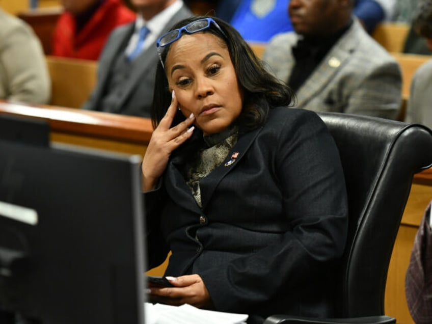 ATLANTA, GEORGIA - NOVEMBER 21: Fulton County District Attorney Fani Willis appears before Judge Scott McAfee for a hearing in the 2020 Georgia election interference case at the Fulton County Courthouse on November 21, 2023 in Atlanta, Georgia. Judge McAfee heard arguments as to whether co-defendant Harrison Floyd should be …