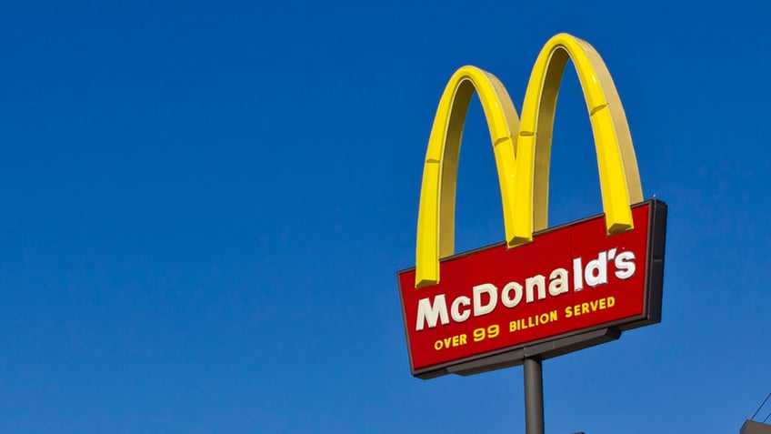 McDonalds sign in front of blue sky.