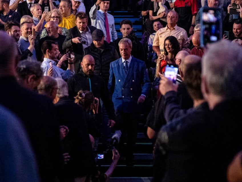 Nigel Farage, leader of Reform UK, center, arrives to speak to local residents during a to