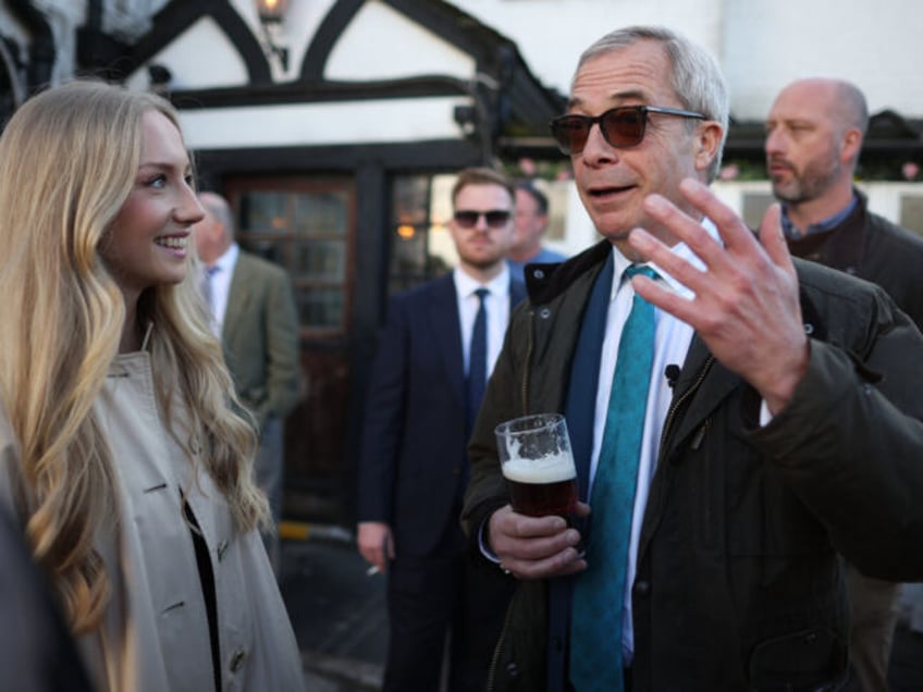 FRODSHAM, ENGLAND - MARCH 24: Reform UK leader, Nigel Farage speaks to people a he drinks