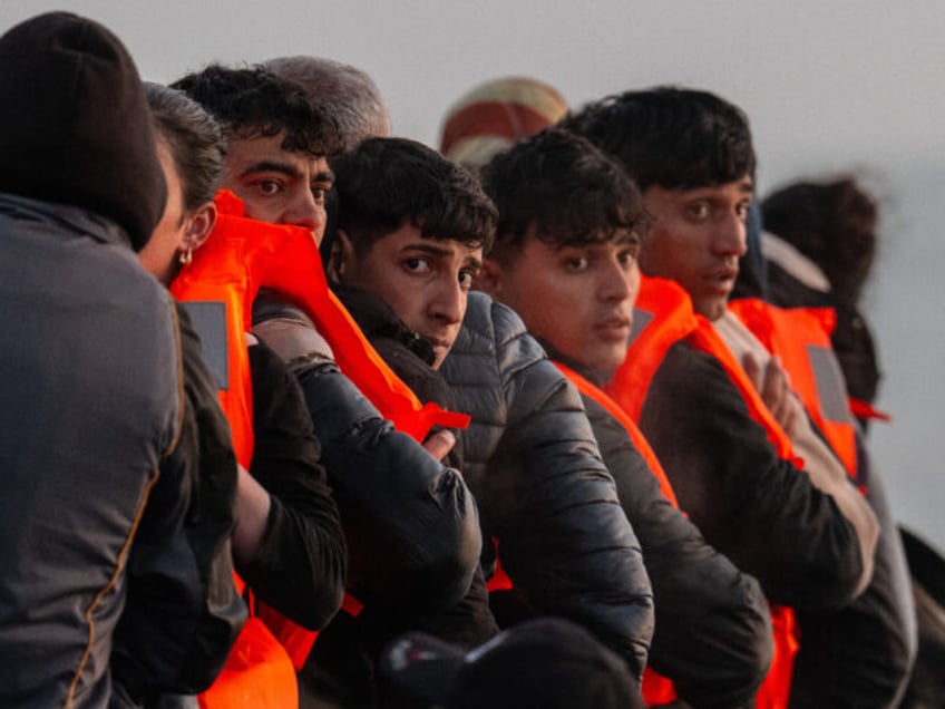 GRAVELINES, FRANCE - MAY 31: Migrants sit on a dinghy as they wait to sail into the Englis