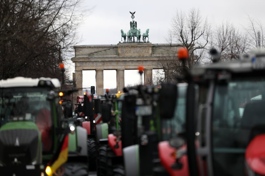 BERLIN, GERMANY - JANUARY 15: Tractors of protesting farmers stand in front of the Brandenburg gate during a large-scale demonstration on January 15, 2024 in Berlin, Germany. Farmers have been protesting across Germany for over a week against proposed government measures that would reduce federal benefits for the agricultural sector. While the coalition government recently stepped back from some of the measures, including proposed taxation of agricultural vehicles and cutting agricultural fuel subsidies, farmers have vowed to press on with their protests in order to stop any measures from being enacted at all. The government is seeking to save EUR 100 million in its agriculture budget. (Photo by Maryam Majd/Getty Images)